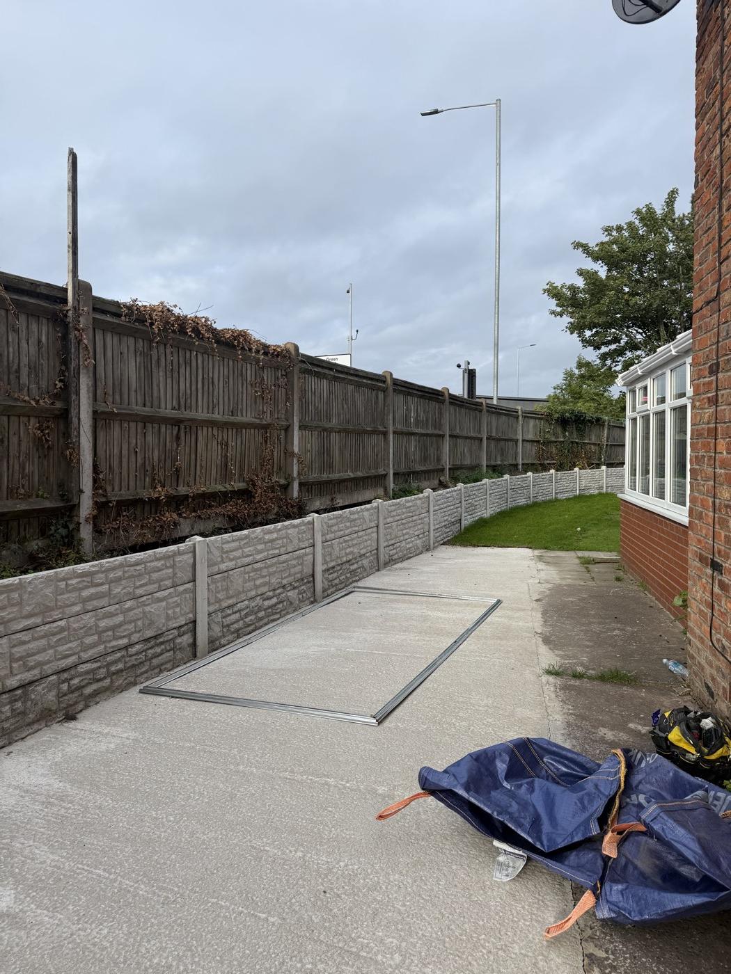 Before: the base frame set out on the concrete