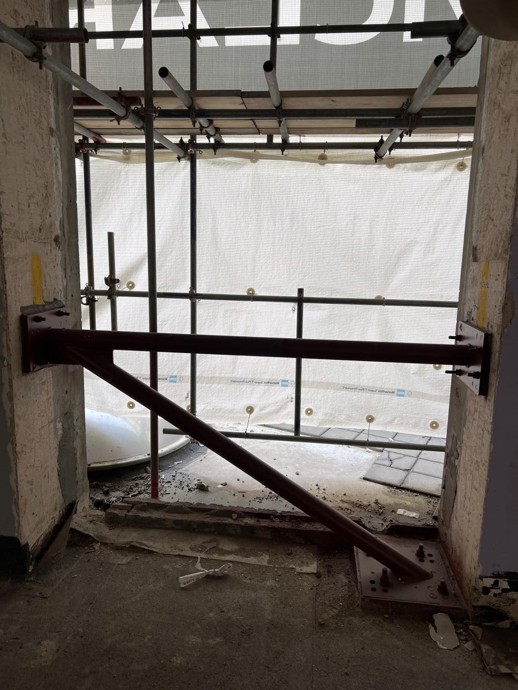 A braced steel frame installed between two columns